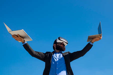 Businessman virtual reality. Future technology concept. Bearded man with laptop outdoor.