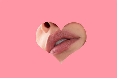 Lips makeup. Woman lip through hole in pink paper. Copy Space. Fashion beauty. Make-up and cosmetics.の写真素材