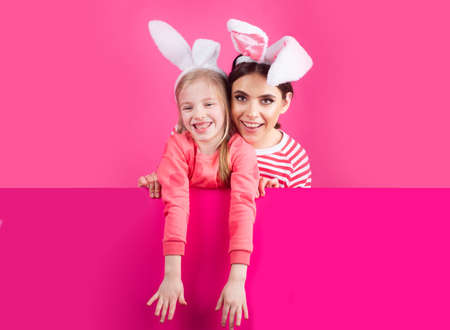 Happy childhood. Girls with bunny ears. Little sister kids celebrate easter. Egg hunt. Spring holiday.の写真素材