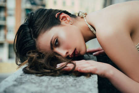 Beautiful girl at balcony. City fashion portrait. Romantic woman.の写真素材