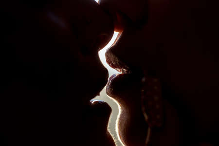Valentines day. Lesbian couple in love. Kissing. Women and mans lips.の写真素材