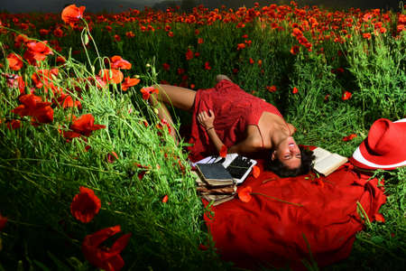 Inspiration from nature. Naked landscape. Spring woman on poppy flower field.の写真素材
