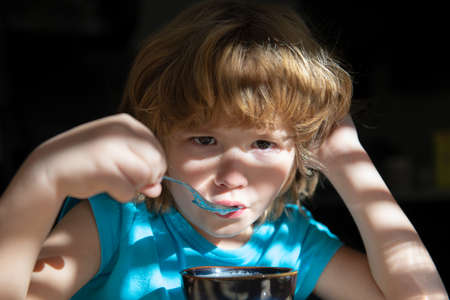 Kids homefood. Boy eats soup. Healthy nutrition for children. Organic home food.の写真素材