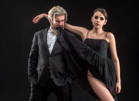 Sexy elegant couple in tender passion. Black background. Seductive love.