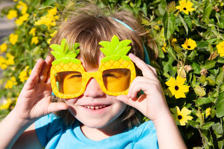 Summer mood. Happy kid in crazy sunglasses. Happy boy in party glasses.
