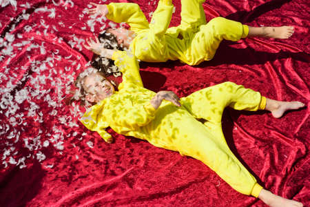 Pajama party. Kids pillow fight. Happy childhood.の写真素材