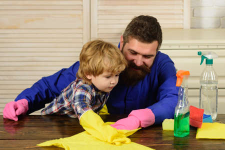 Father and son cleaning. Man accustoms the boy to cleanliness.の写真素材
