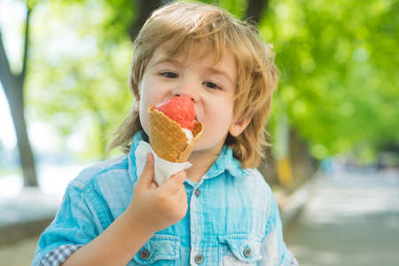Kid eat icecream outdoor. Kids junk food. Delicious summer ice cream.