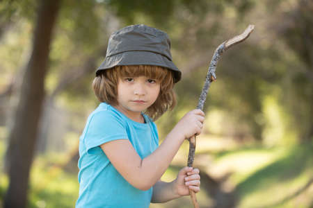 Child aggression. Negative kids emotion. Angry boy with stick. Kid adaptation. Bully. Bullying concept. nervous breakdownの写真素材