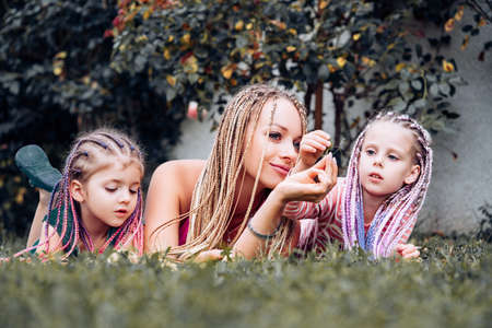 Mothers day. Little daughter hugging mother. Mom and kid girl spending time together.の写真素材