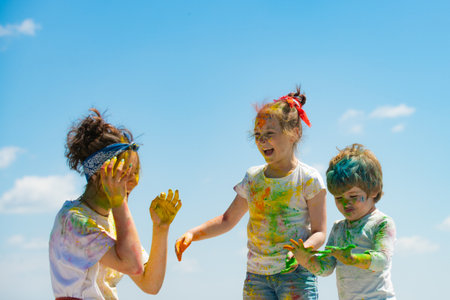 Portrait of a cute kids painted in the colors of Holi festival.の写真素材