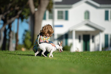 Little cute boy child with dog relaxing on nature.の写真素材