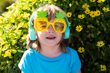 Smiling child with sunglasses outdoor. Summer kids time. Boy in crazy pineapple sun glasses.の写真素材