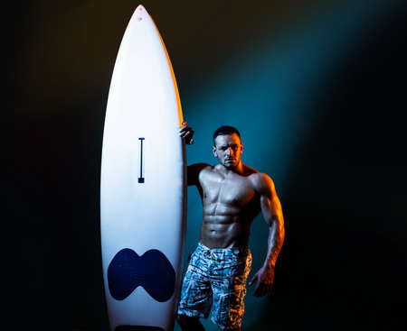 Sexy muscular summer boy. Handsome man with serf board or surfboard with athlete, fit and firm body.