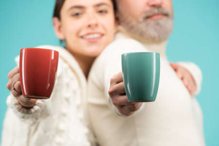Family coziness concept. Happy couple at routine morning with cup of coffee or tea. Enjoying nice...