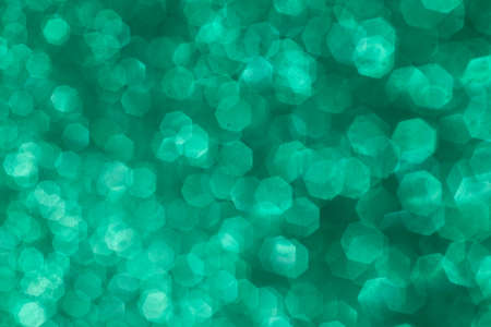 Green glitter bokeh. Abstract background sparkles. Festive background. Abstract Christmas.