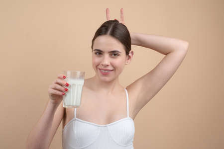 Vegan people concept. Vegetarian woman. Take in veggie. Cow goat girl, healthy lifestyle. Organic field for cow-milk.の写真素材