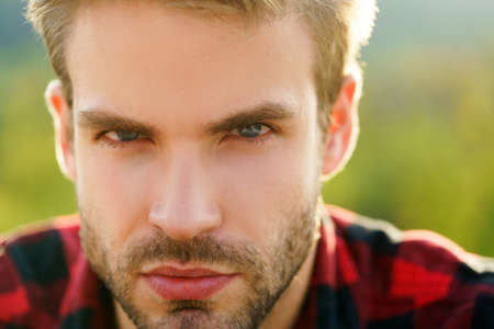 Closeup of handsome man portrait. Bearded hipster, serious emotions, gay guy.の写真素材