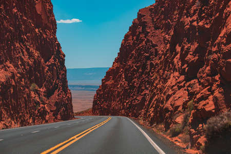 American road trip. Road against the high rocks.の写真素材