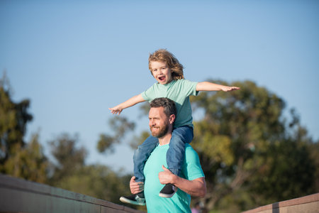 Father and son outside. People having fun outdoors. Concept of happy vacation and friendly family.