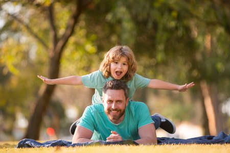 Father and son spending time outdoor together. Happy men family concept.の写真素材