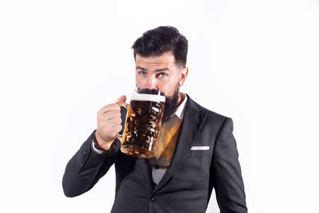 Happy elegant man drinking beer. Happy brewer holding glass with beer.の写真素材