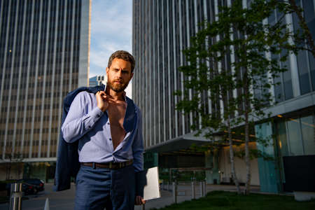 Business people. Businessman in open suit near city street.