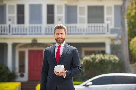Business man holding savings piggy bank.の写真素材