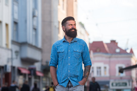 young handsome bearded hipster man in the city