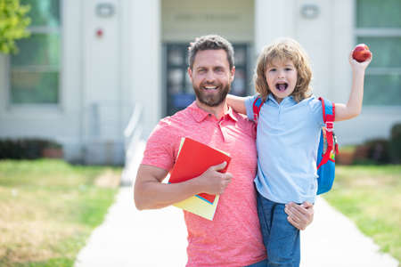 Portrait of happy father and son come back from school.の写真素材