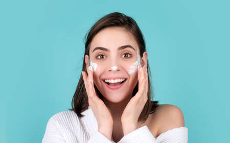 Moisture for skin. Beautiful woman apply a cleansing mask on face. Female skin care, close up face beauty portrait.の写真素材