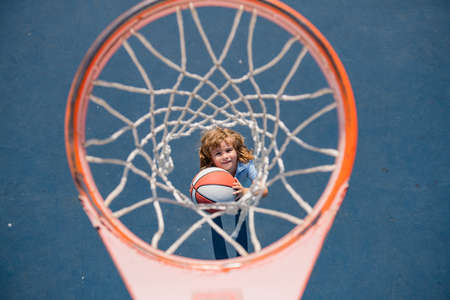 Angle view from on top of kid playing basketball on playground.の写真素材