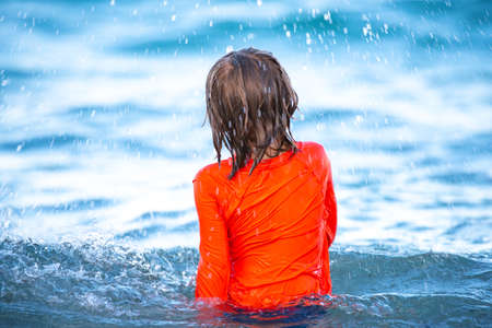 Kids summer vacation. Boy in ocean sea. Child at beach. Active lifestyle.の写真素材