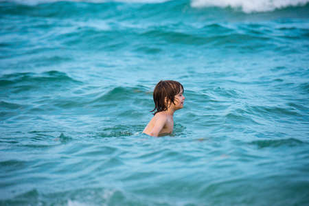 Kid having fun on summer vacation at beach sea. Travel and adventure concept. Vacation with children.の写真素材