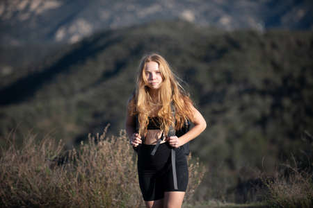 Woman hiker tourist at mountain. Girl hiking a hill at panoramic point. Backpacking tourism concept.の写真素材
