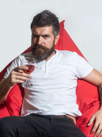 Home alone party. Hipster with glass of wine. Man with alcohol.の写真素材