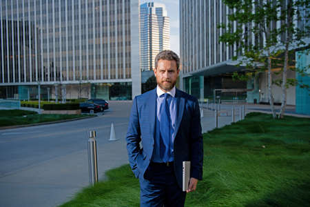 Businessman with success business. Outdoors portrait male model in suit.