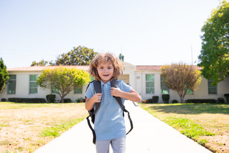 Elementary school kid running at school. Kids education concept.の写真素材