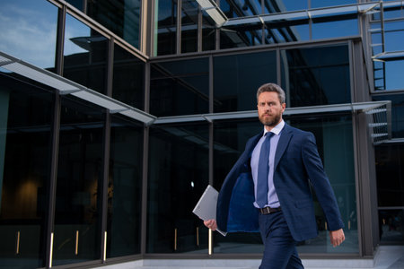 Portrait of businessman standing in a office.の写真素材