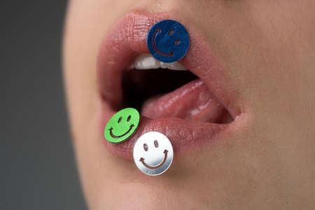 Creative makeup. Female lips with sparkles. Smiley emoticon emoji.