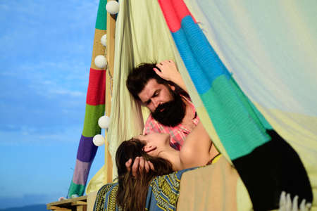 Couple in tent. Pair in love hugging and kissing in camping. Happy man woman hug outdoor.
