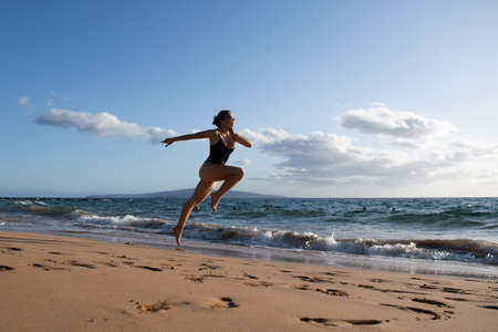 Woman running silhouette. Run on sea. Sport exercise at beach concept.