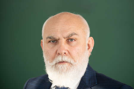 Closeup face of professor or teacher on blackboard isolated. Senior professor with gray hair in...