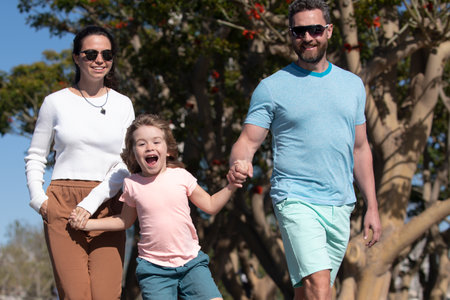 Family in the city. Family walking in urban park. Childhood and parenting concept.の写真素材