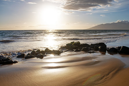 Sunset. Beach with golden sand, turquoise ocean water. Panoramic sea view. Natural background for summer vacation.の写真素材