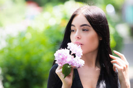 Portrait of beautiful model with make up outdoor. Beauty girl face. Woman with flowers.
