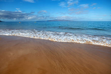 Calm sea beach background. Summer tropical beach with sand. Ocean water. Natural seascape.の写真素材