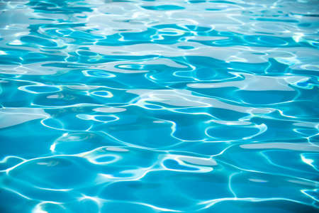 Abstract ripple wave and clear turquoise water surface in swimming pool, blue water wave for...