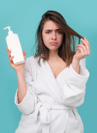 Woman hold bottle shampoo and conditioner. Woman hair loss problem for health haircare shampoo,...
