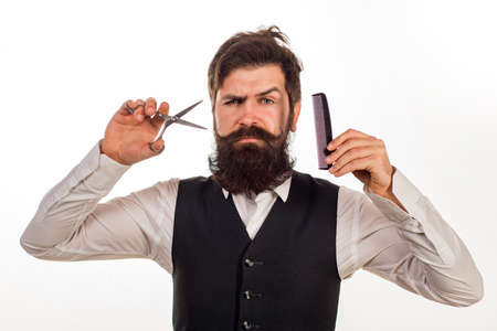Bearded man, portrait of man with long beard and moustache. Barber scissors and comb for barber shop. Vintage barbershop, shaving.の写真素材